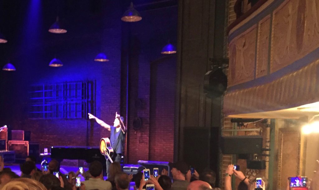 Springsteen stands on a Broadway stage and points to the crowd after the show.